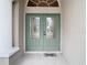 Double green front doors with glass panels at 12312 Millington Ave, Weeki Wachee, FL 34614