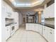 Spacious kitchen features white cabinets, granite counters, and views to the Gathering room at 12312 Millington Ave, Weeki Wachee, FL 34614