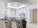 Modern kitchen with breakfast bar, white cabinets, and granite countertops at 12312 Millington Ave, Weeki Wachee, FL 34614