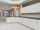 Well-equipped kitchen with white cabinets, granite countertops, and modern appliances at 12312 Millington Ave, Weeki Wachee, FL 34614