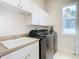 Laundry room with washer, dryer, cabinets and sink at 12312 Millington Ave, Weeki Wachee, FL 34614