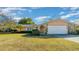 Single-story house with a peach-colored exterior, stone accents, and a spacious yard at 1318 Altoona Ave, Spring Hill, FL 34609