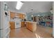Kitchen with island, wood cabinets and tile floor, open to dining area at 1318 Altoona Ave, Spring Hill, FL 34609