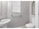 Clean and bright half bathroom with pedestal sink and toilet at 13468 Haverhill Dr, Spring Hill, FL 34609