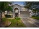 Two-story house with a large front yard, double doors, and attached garage at 13468 Haverhill Dr, Spring Hill, FL 34609