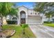 Two-story house with a large front yard and double doors at 13468 Haverhill Dr, Spring Hill, FL 34609