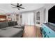 Living room with sectional sofa, built-in shelving, and large window at 13468 Haverhill Dr, Spring Hill, FL 34609