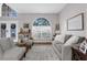 Spacious living room with gray sofas, large window, and wood floors at 13468 Haverhill Dr, Spring Hill, FL 34609