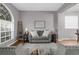 Living room featuring a gray sectional sofa and large window at 13468 Haverhill Dr, Spring Hill, FL 34609