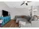 Spacious living room featuring a large sectional sofa and wood-look floors at 13468 Haverhill Dr, Spring Hill, FL 34609