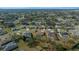 An elevated view shows the property nestled in a tranquil neighborhood with tree-lined streets and well-manicured yards at 14215 Presteign Ln, Spring Hill, FL 34609