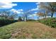 Expansive backyard featuring lush greenery and mature trees, providing ample space for outdoor activities and relaxation at 14215 Presteign Ln, Spring Hill, FL 34609