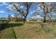 A sprawling backyard with mature trees, providing privacy and a tranquil setting for outdoor enjoyment at 14215 Presteign Ln, Spring Hill, FL 34609