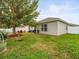 Private backyard with grassy area and home view at 14284 Finsbury Dr, Spring Hill, FL 34609