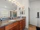 Double vanity bathroom with granite countertops and a large mirror at 14284 Finsbury Dr, Spring Hill, FL 34609