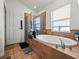 Relaxing bathroom with a garden tub, walk-in shower, and updated fixtures at 14284 Finsbury Dr, Spring Hill, FL 34609
