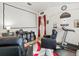 Home theater with large screen, comfortable seating and treadmill at 14284 Finsbury Dr, Spring Hill, FL 34609