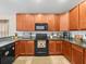 Well-equipped kitchen featuring granite countertops and black appliances at 14284 Finsbury Dr, Spring Hill, FL 34609