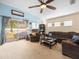 Open living room with blue accent wall, comfortable seating, and a view of the backyard at 14284 Finsbury Dr, Spring Hill, FL 34609
