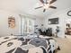 Spacious main bedroom with king-size bed, large window, and a separate workspace at 14284 Finsbury Dr, Spring Hill, FL 34609