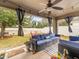 Covered patio with seating area and backyard view at 14284 Finsbury Dr, Spring Hill, FL 34609
