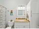 Bathroom with single vanity, shower and decorative art at 2013 Gulfview Dr, Holiday, FL 34691