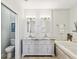 Double vanity bathroom with granite countertops and soaking tub at 2013 Gulfview Dr, Holiday, FL 34691
