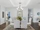 Elegant dining room featuring a glass table and white chairs at 2013 Gulfview Dr, Holiday, FL 34691