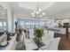 Elegant dining area with glass table, white chairs, and waterfront views at 2013 Gulfview Dr, Holiday, FL 34691