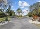 Long driveway leading to a waterfront home with landscaping at 2013 Gulfview Dr, Holiday, FL 34691