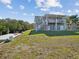 Two-story home with a large covered patio, deck, and fenced backyard at 2013 Gulfview Dr, Holiday, FL 34691