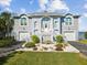 Two-story waterfront home with landscaped yard and attached two-car garage at 2013 Gulfview Dr, Holiday, FL 34691