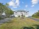 Two-story waterfront home with a fountain and attached two-car garage at 2013 Gulfview Dr, Holiday, FL 34691
