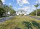 House with circular driveway and fountain in front yard at 2013 Gulfview Dr, Holiday, FL 34691