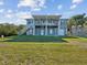 Two-story home with a large covered patio and grassy yard at 2013 Gulfview Dr, Holiday, FL 34691