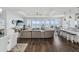Spacious living room with hardwood floors, sectional sofa, and stunning water views at 2013 Gulfview Dr, Holiday, FL 34691