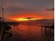 Vibrant sunset over calm water with dock in foreground at 2013 Gulfview Dr, Holiday, FL 34691