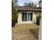 Small patio with sliding glass doors and lush green grass at 3039 Sandpiper Ct, Clearwater, FL 33762