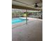 Large patio area with pool view and ceiling fan at 3039 Sandpiper Ct, Clearwater, FL 33762