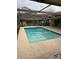 Inviting pool area with covered patio and screened enclosure at 3039 Sandpiper Ct, Clearwater, FL 33762