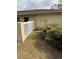 Side yard with a white fence, gate, and landscaping at 3039 Sandpiper Ct, Clearwater, FL 33762