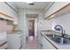 Kitchen with double sink and white cabinets at 3820 59Th W Ave # 3820, Bradenton, FL 34210