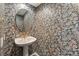 Powder room with pedestal sink and floral wallpaper at 4412 Lake In The Woods Dr, Spring Hill, FL 34607