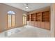Bright bedroom featuring built-in shelving and hardwood floors at 4412 Lake In The Woods Dr, Spring Hill, FL 34607