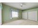 Bedroom with double door closet and ceiling fan at 4412 Lake In The Woods Dr, Spring Hill, FL 34607