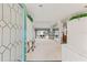 Bright and spacious entryway with glass door and mirrors at 4412 Lake In The Woods Dr, Spring Hill, FL 34607