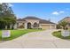 Beautiful home with a large driveway and mature landscaping at 4412 Lake In The Woods Dr, Spring Hill, FL 34607