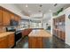 Eat-in kitchen with center island and stainless steel appliances at 4412 Lake In The Woods Dr, Spring Hill, FL 34607