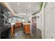 Kitchen with an island, ample cabinetry, and granite countertops at 4412 Lake In The Woods Dr, Spring Hill, FL 34607