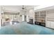 Open living room with fireplace and view of the kitchen and pool at 4412 Lake In The Woods Dr, Spring Hill, FL 34607
